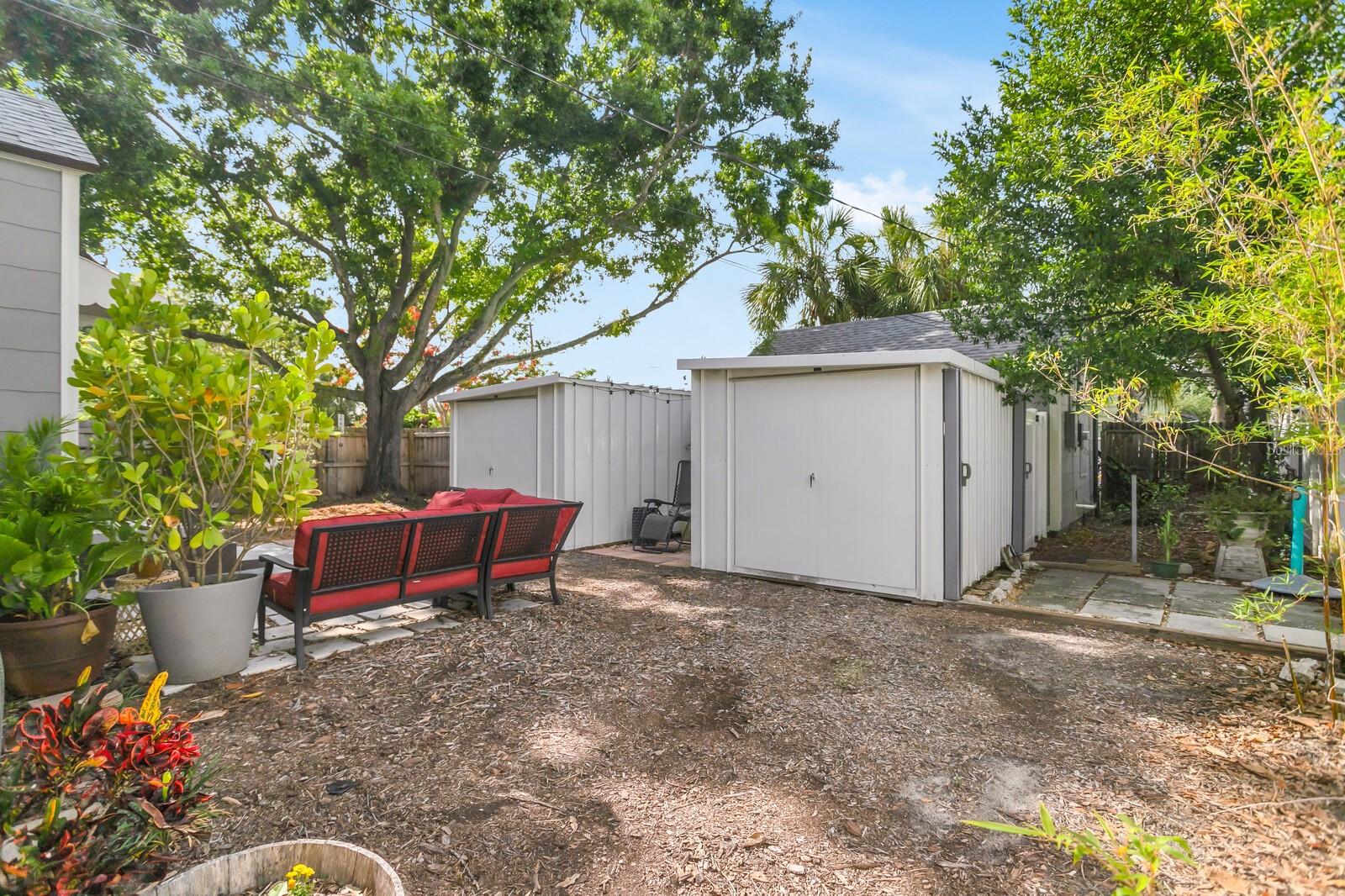 two storage sheds in backyard