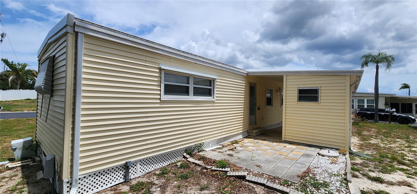 Concrete pad behind shed and carport