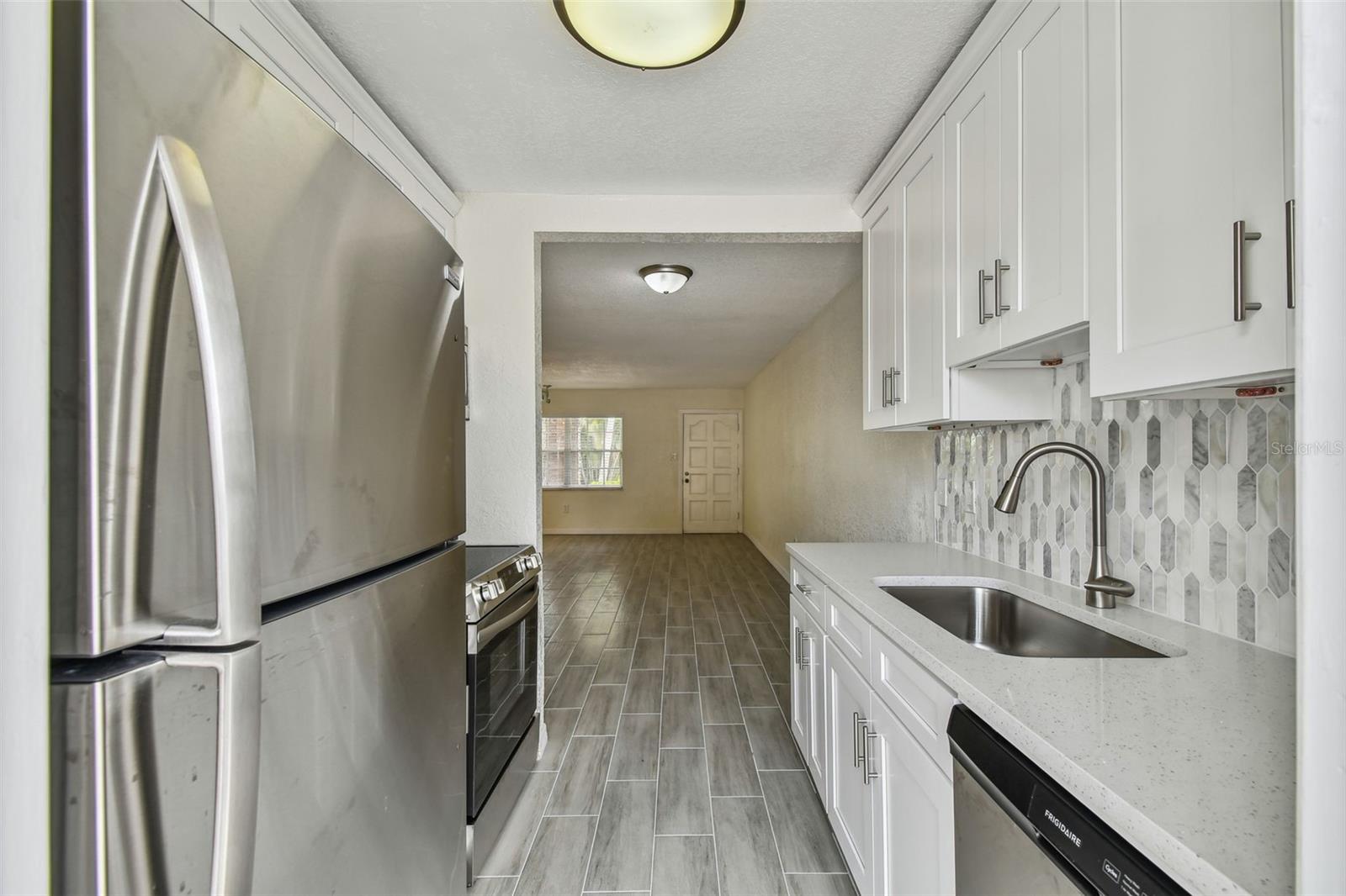 Kitchen Long view into Family Room Area