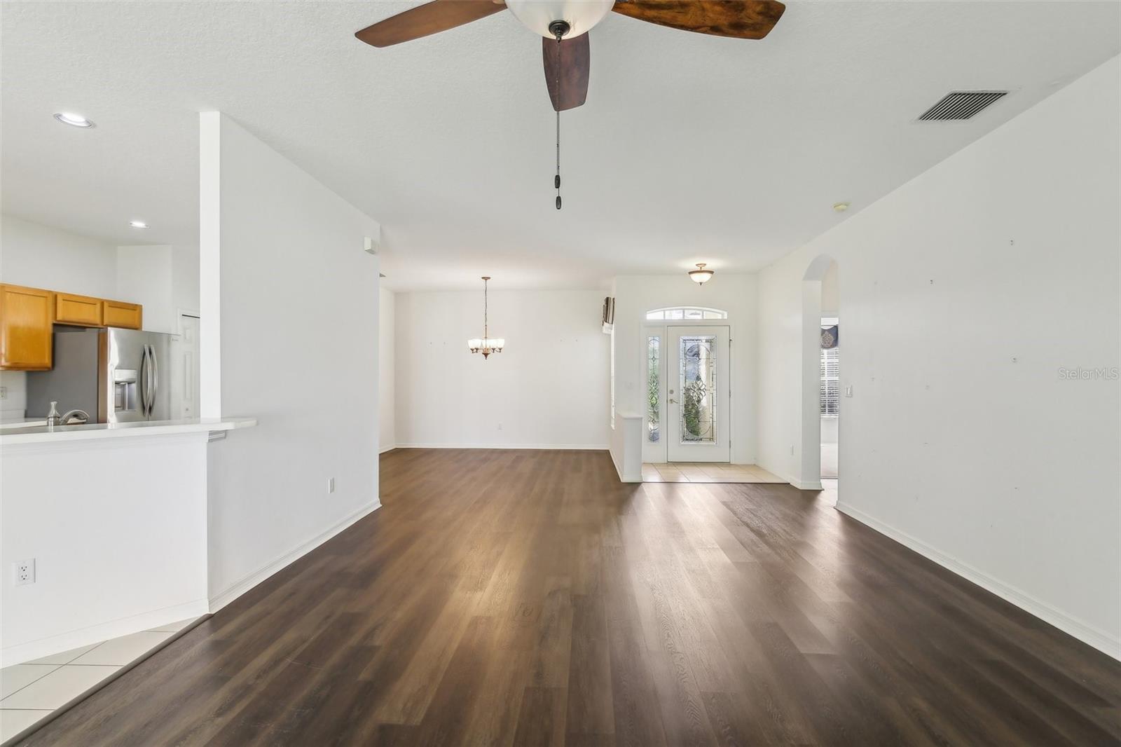 VIEW OF ENTRY, KITCHEN AND DINING ROOM FROM THE FAMILY ROOM