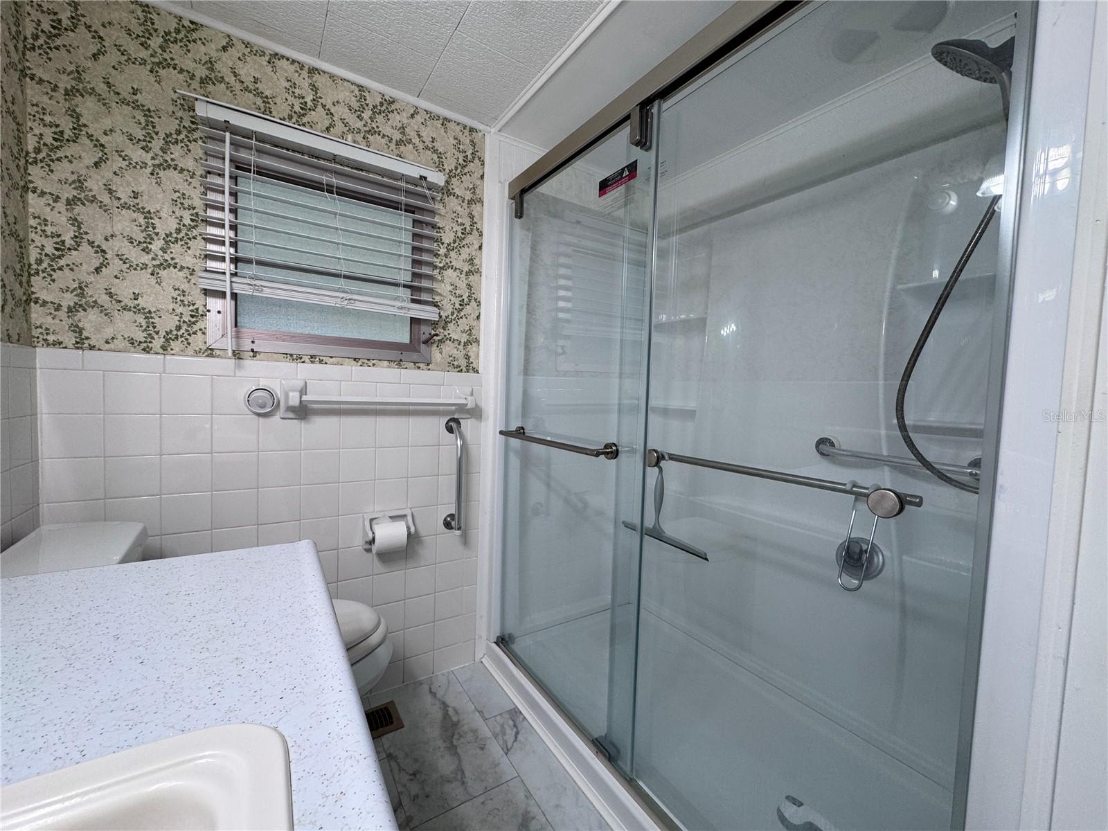 Full bathroom with walk in shower.