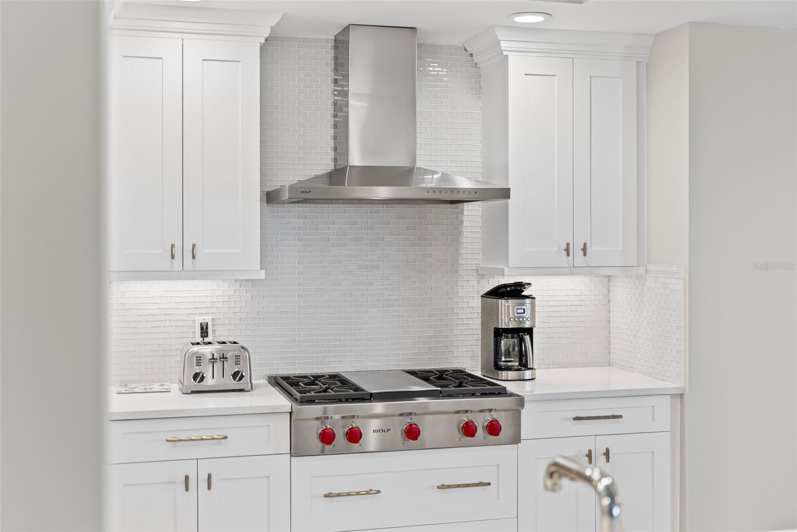 Top of the line appliances including a WOLF GAS stove
