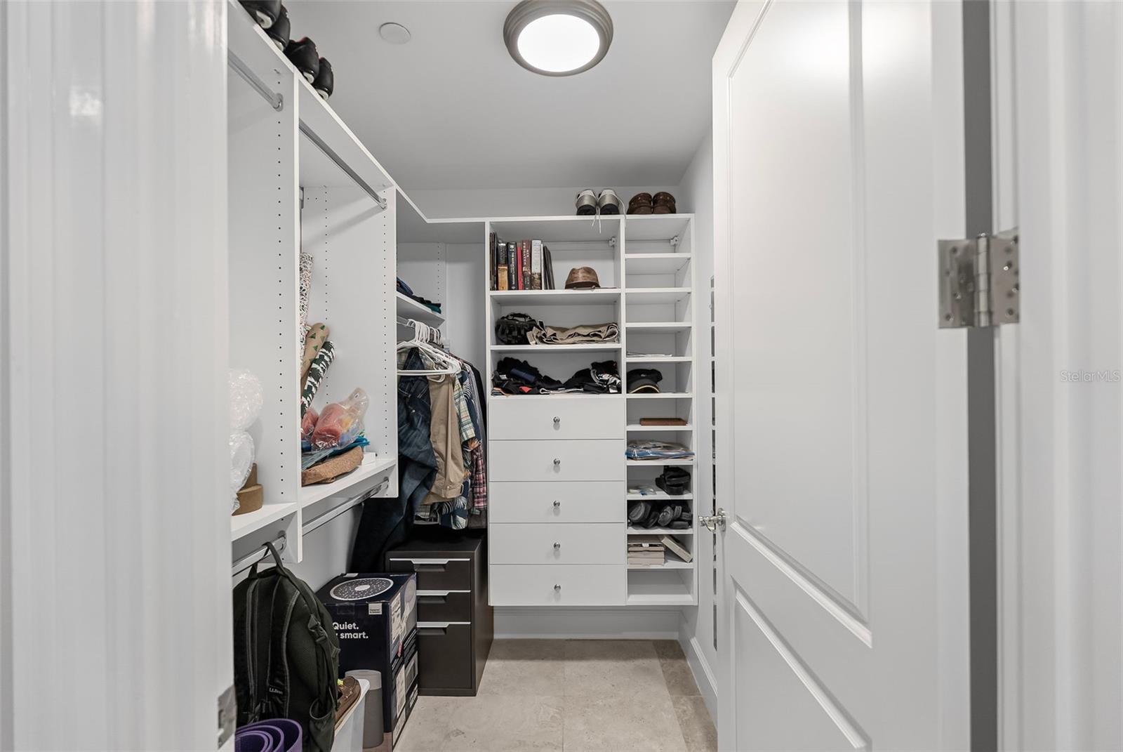 One of two walk-in closets connected to the primary bedroom