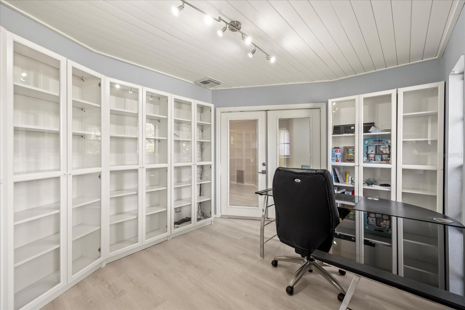 "Sound proof" office.  Owners Installed exterior french doors making this office very private with views of the front garden.