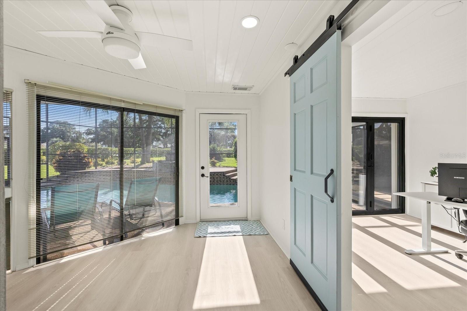 Flex space for homework, or a "butler's pantry" servicing the dining room. Also, barn door to 2nd home office with gorgeous new accordian sliders to pool.