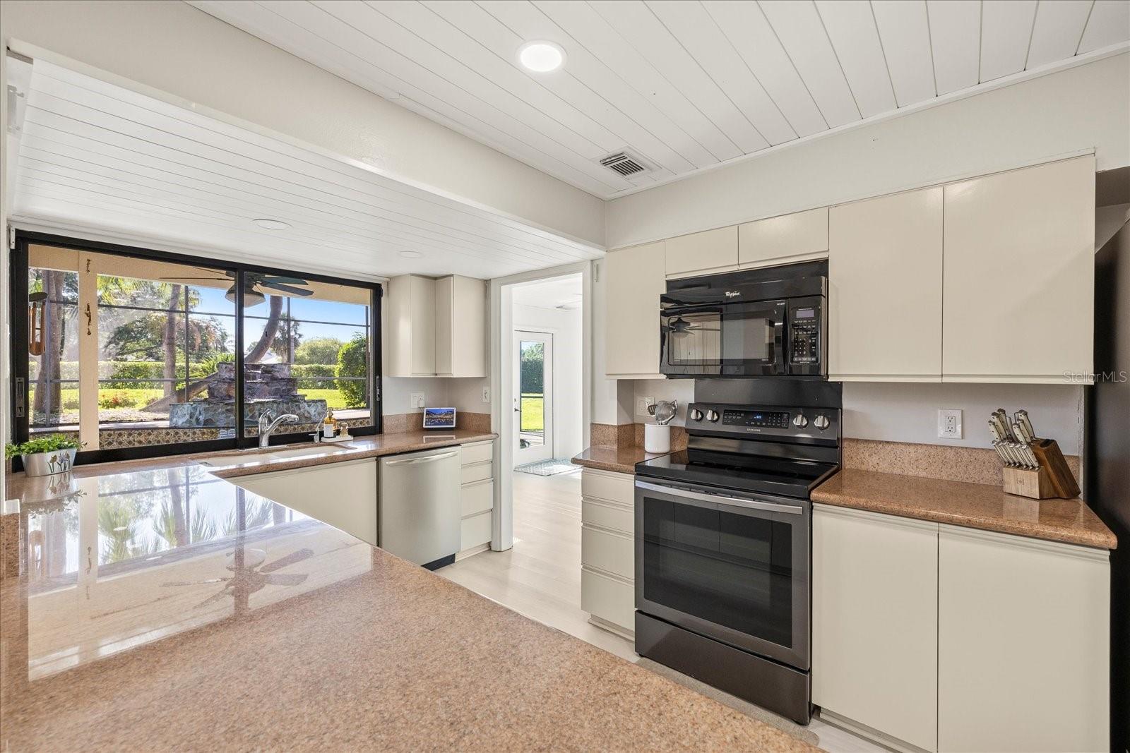 Beautiful view of the pool from the sink.  Window opens for even more outdoor/indoor entertaining options.