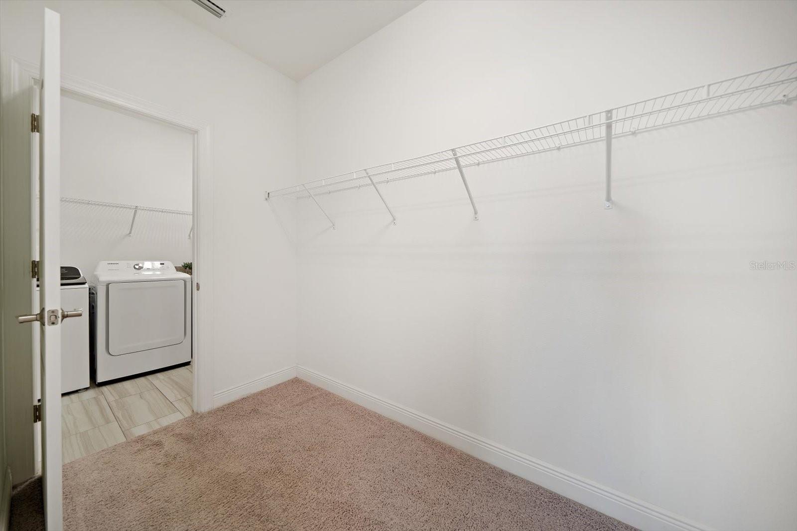 Primary Walk-In Closet to Laundry Room