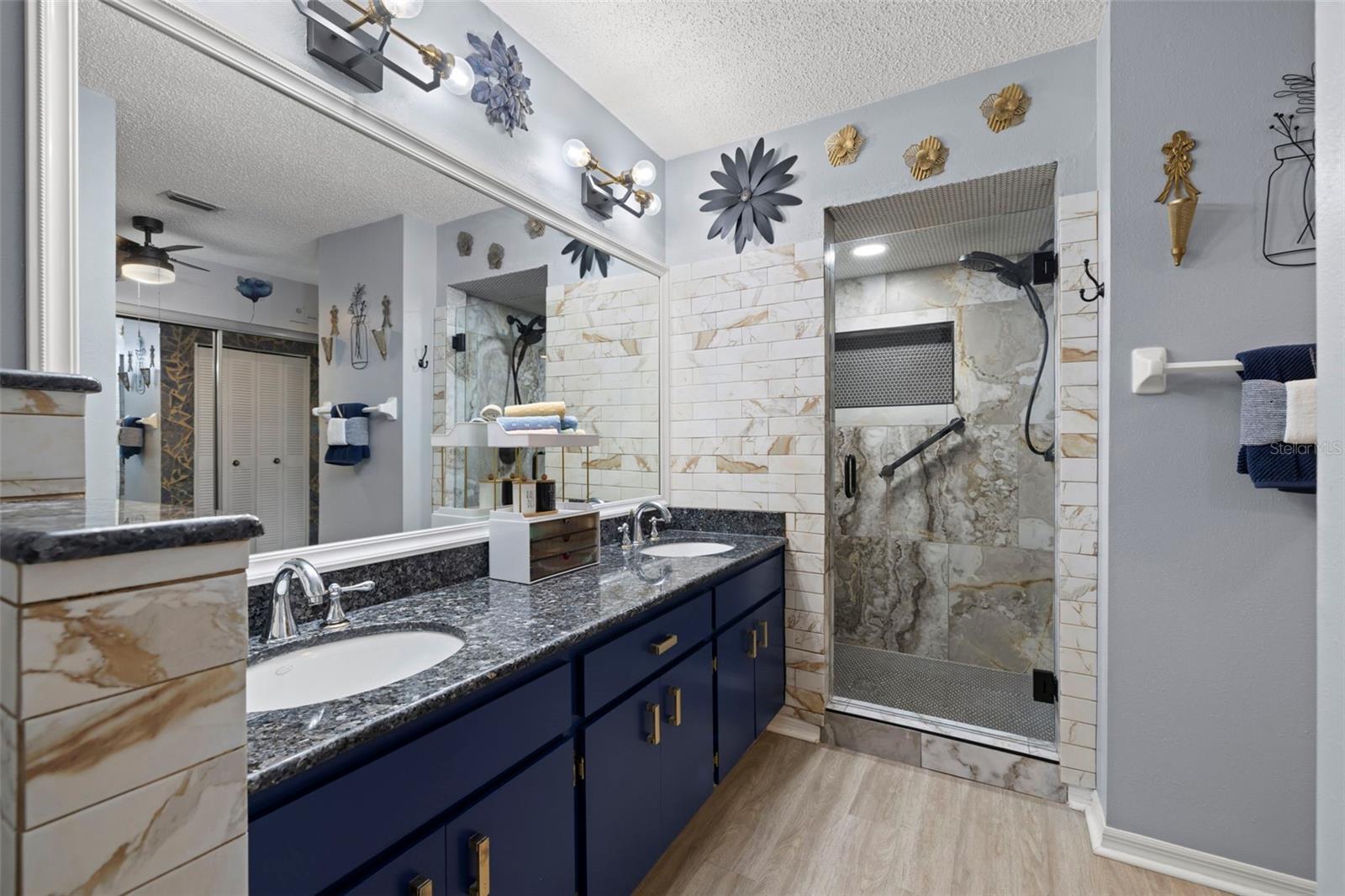 Granite countertops and a gorgeous tile shower