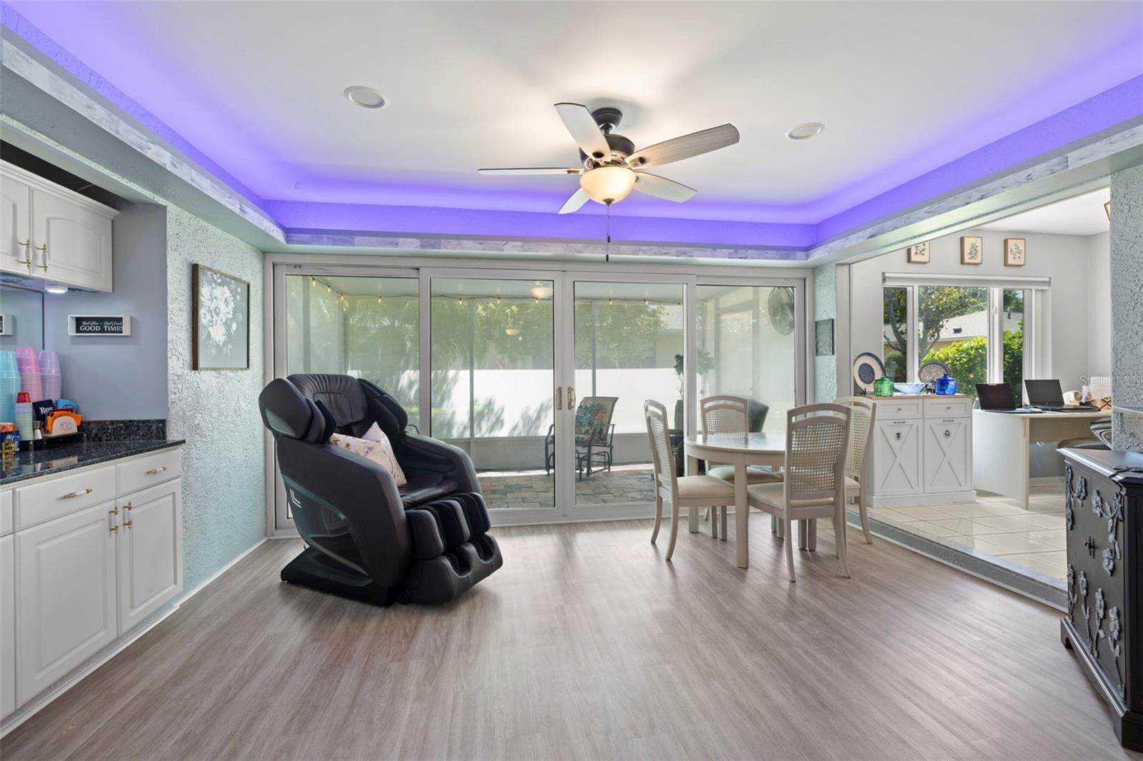 Florida room w/ wall of sliding glass doors & overhead lighting