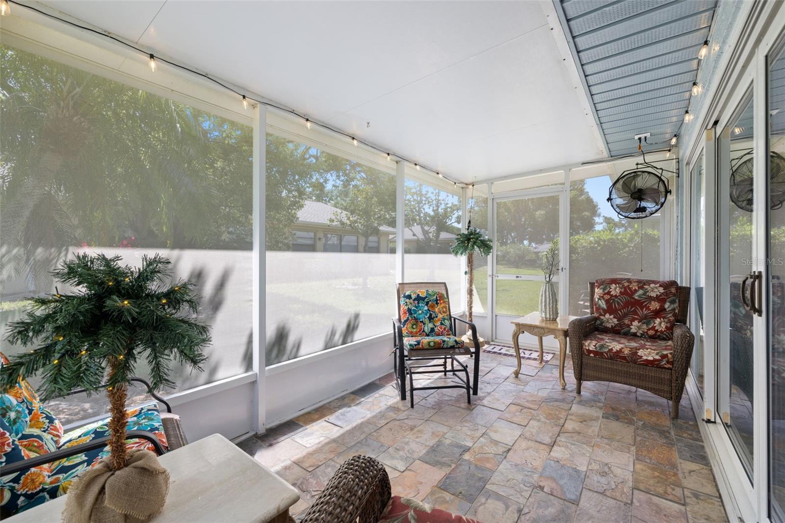 Rear patio with privacy screen and slate floors