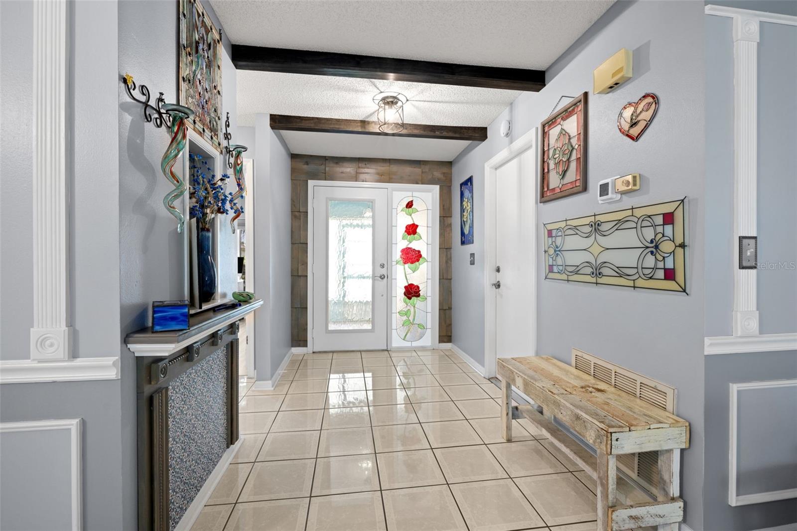 Foyer - Stained glass door and sidelight, overhead beams, accent wall
