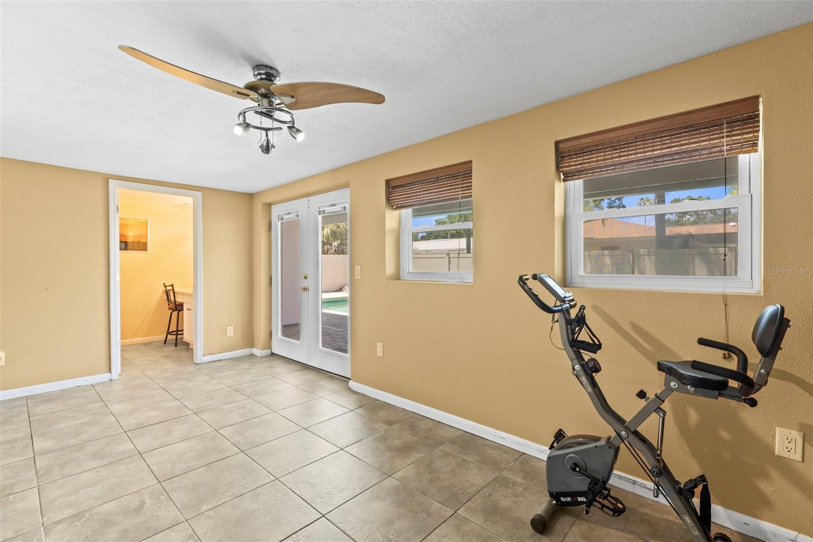 Family room with french doors leading to the pool