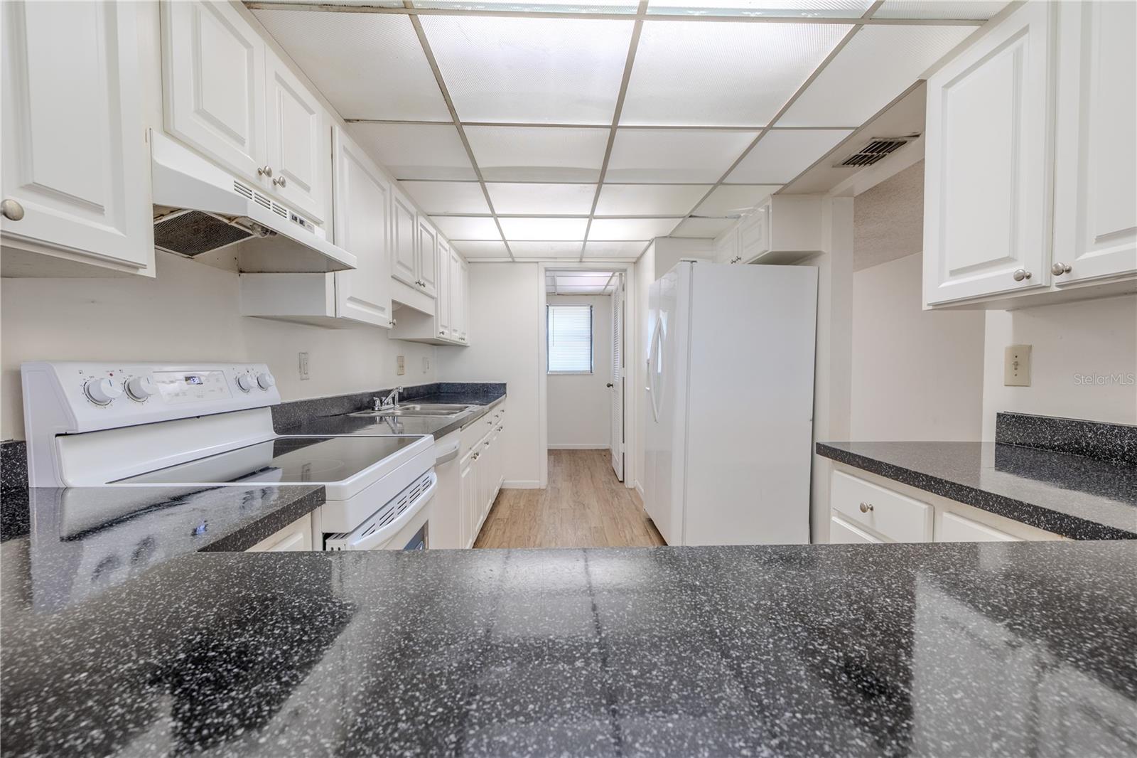 The kitchen features granite like finish on countertops.