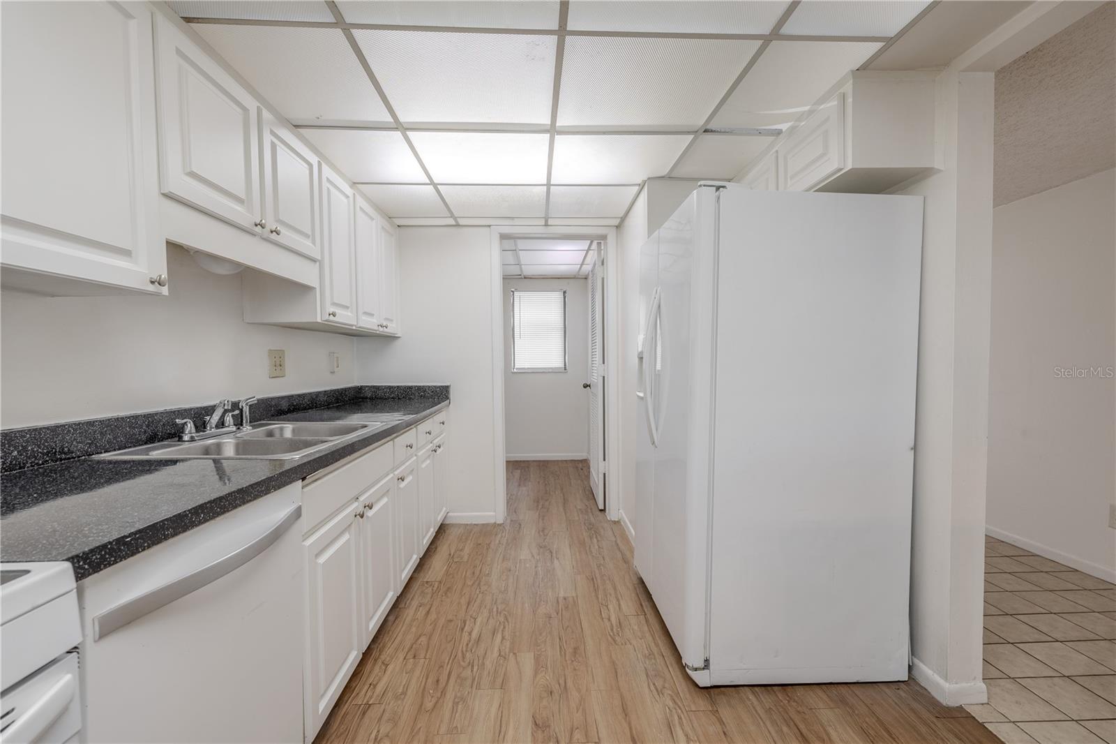 The kitchen features a full suite of appliances including a NEW range, a dishwasher and refrigerator.