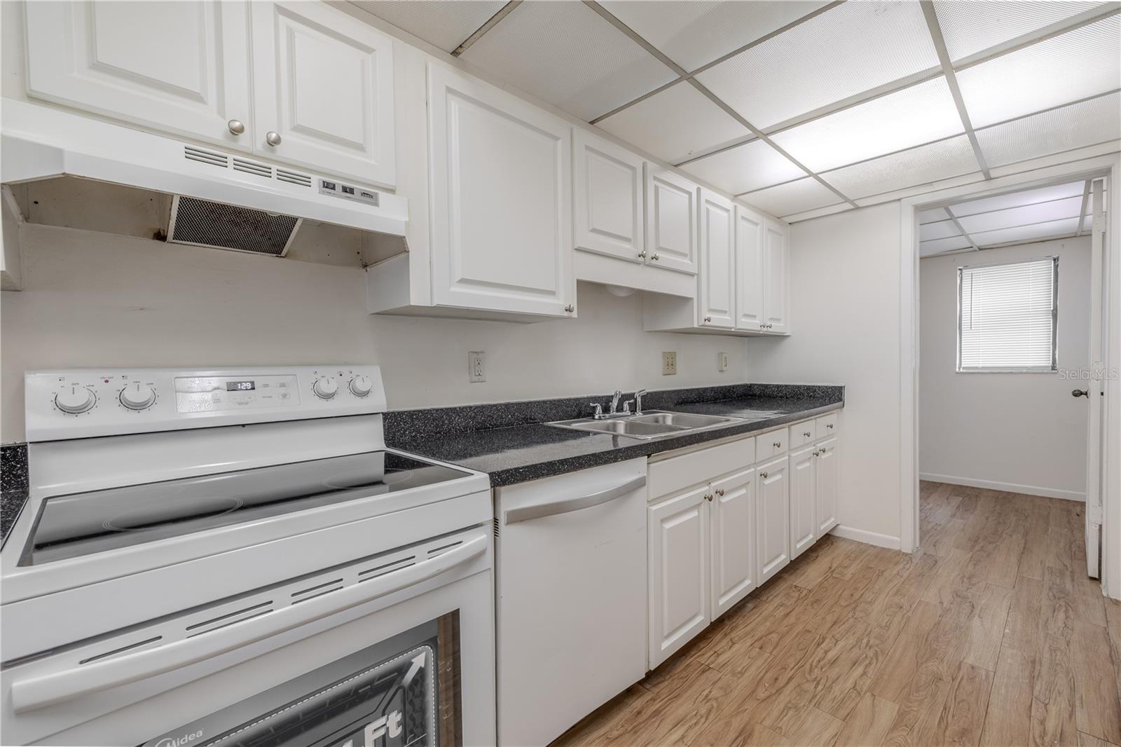 The kitchen features a dual basin, stainless steel sink.