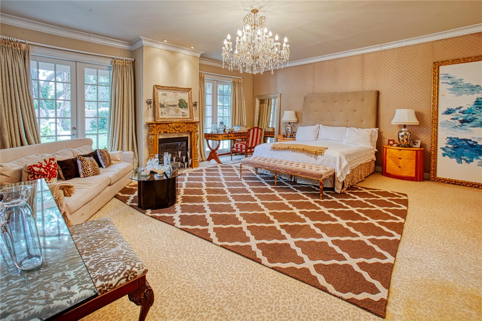 Downstairs primary suite with fireplace and french doors to the outside