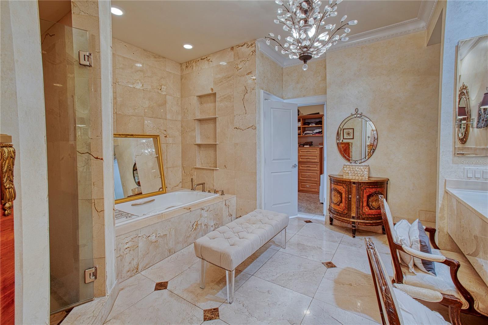Marble primary bath with walk in shower, dual sinks and garden tub