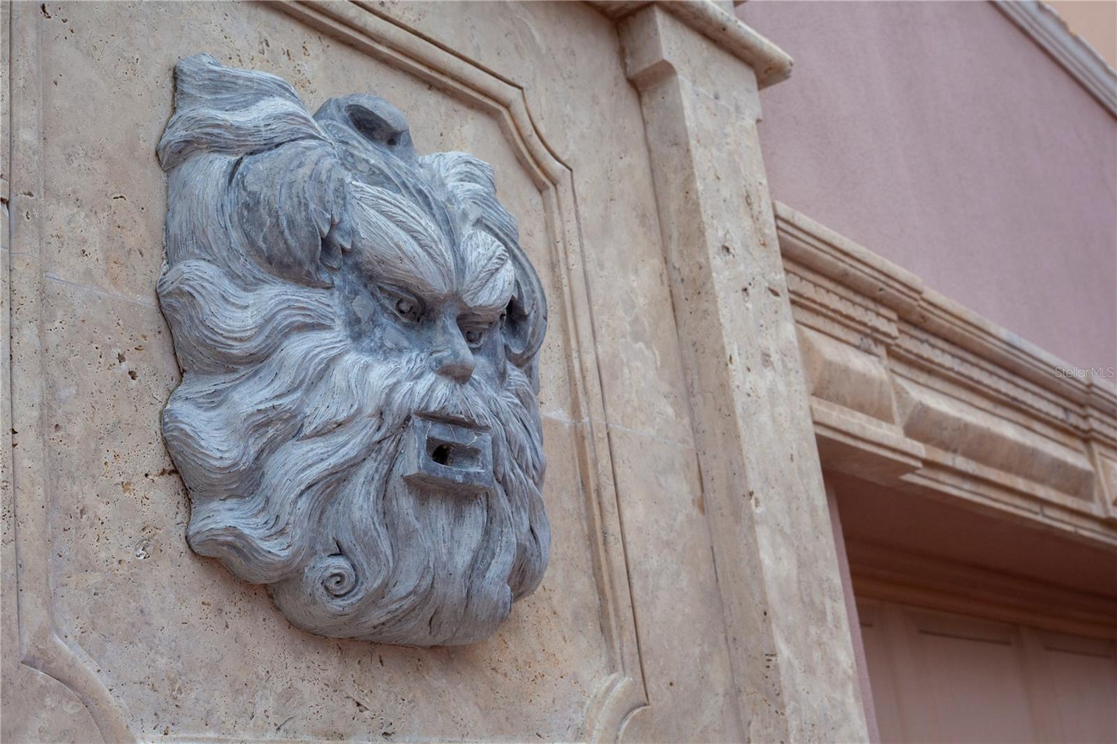 Detail view of the hand carved marble fountain in front of the garage