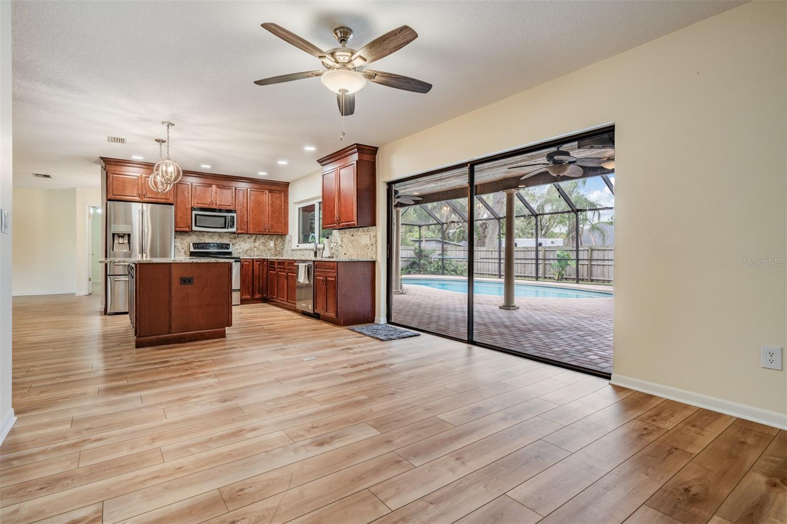Family room/kitchen combination with slider to lanai and pool