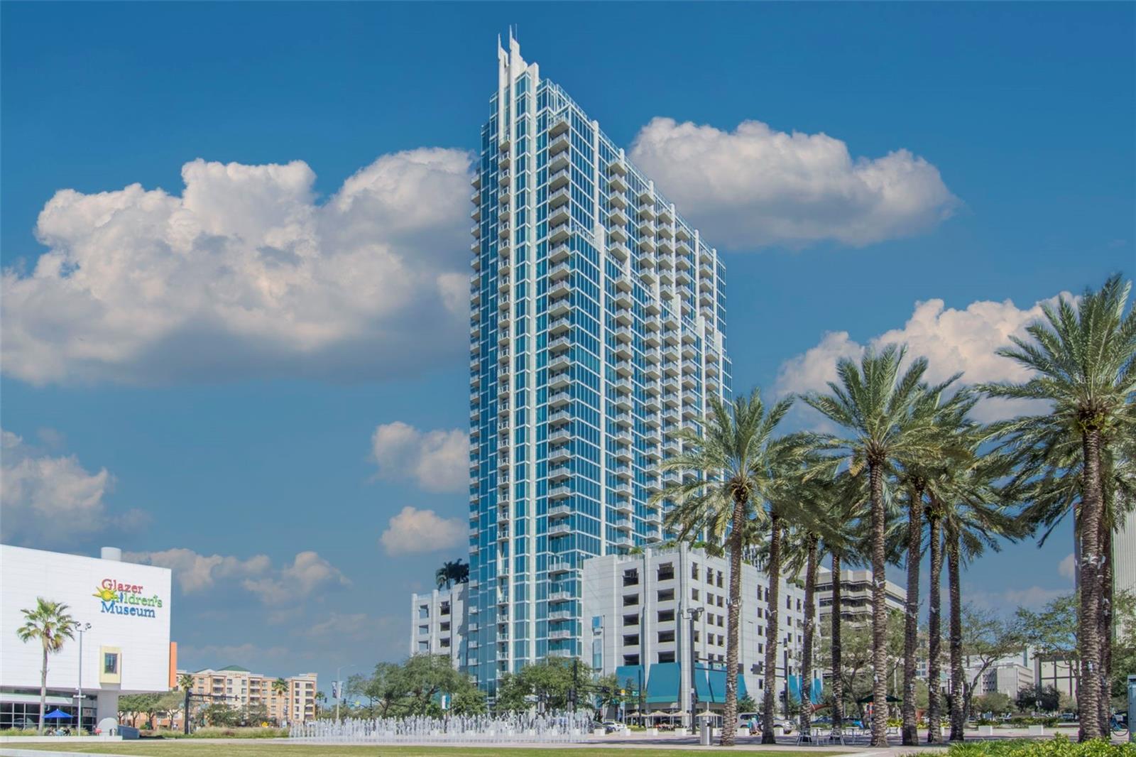 Striking glass-front façade of Skypoint High-Rise at 777 N Ashley Dr, steps from Curtis Hixon Park, Glazer Children’s Museum, and the Tampa Riverwalk.