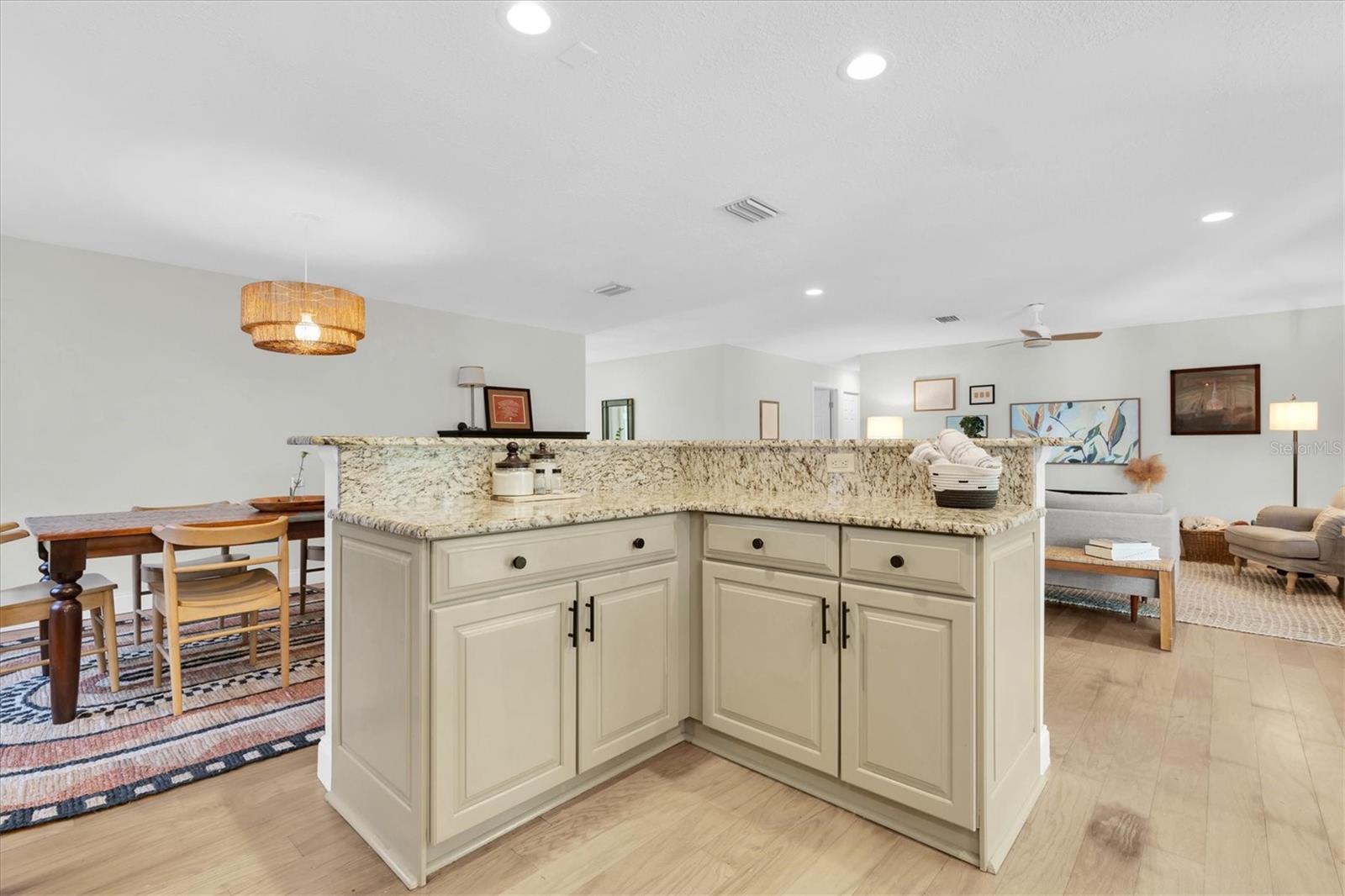 Kitchen looking to living room and dining