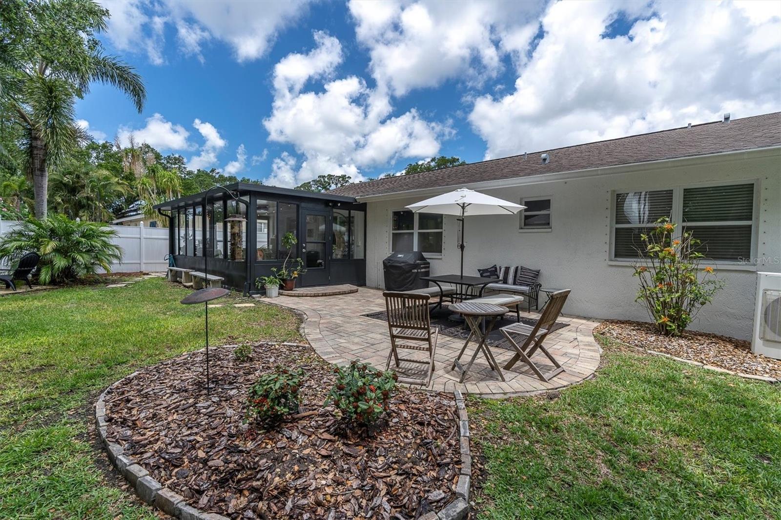 Backyard look to Bonus Room with Patio Area