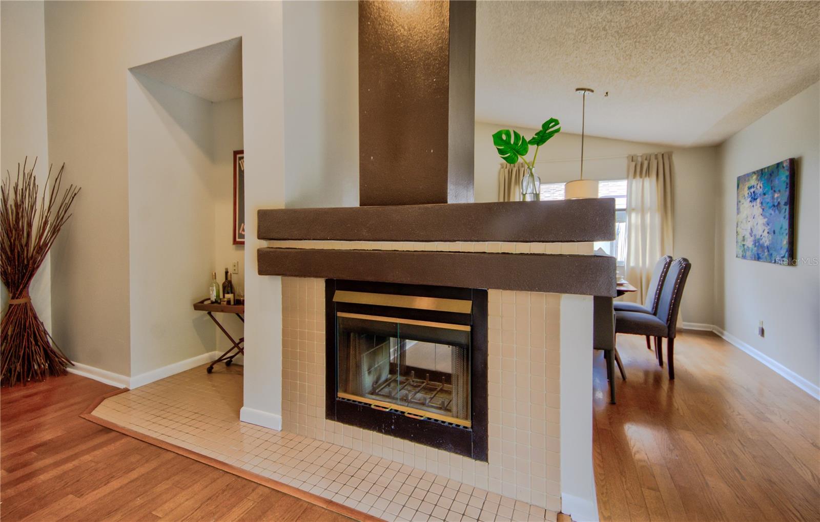 Double Sided Fireplace Leading to Dining Room