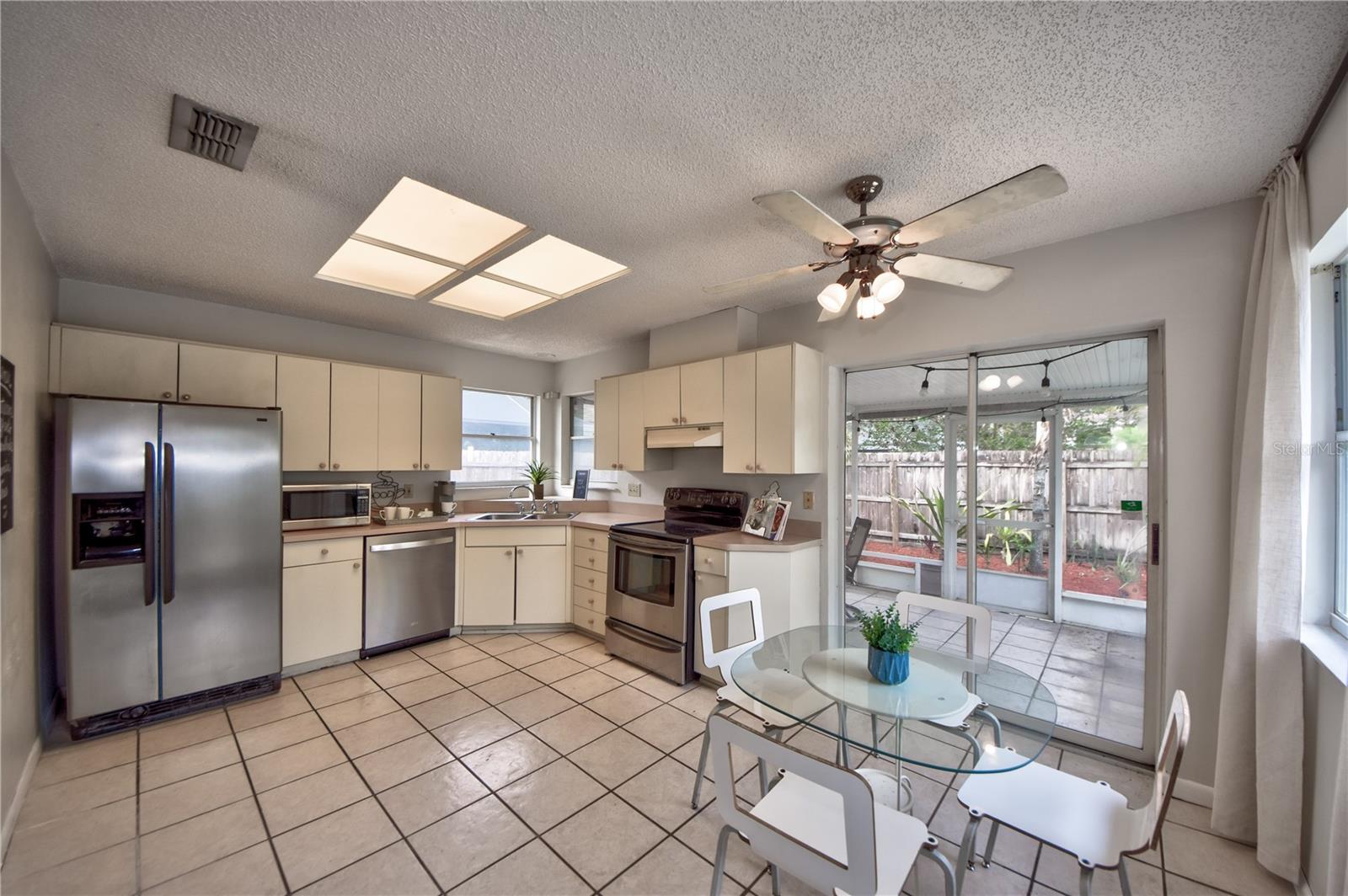 Kitchen W/ Breakfast Nook and sliders leading to Covered Patio/Pool Area