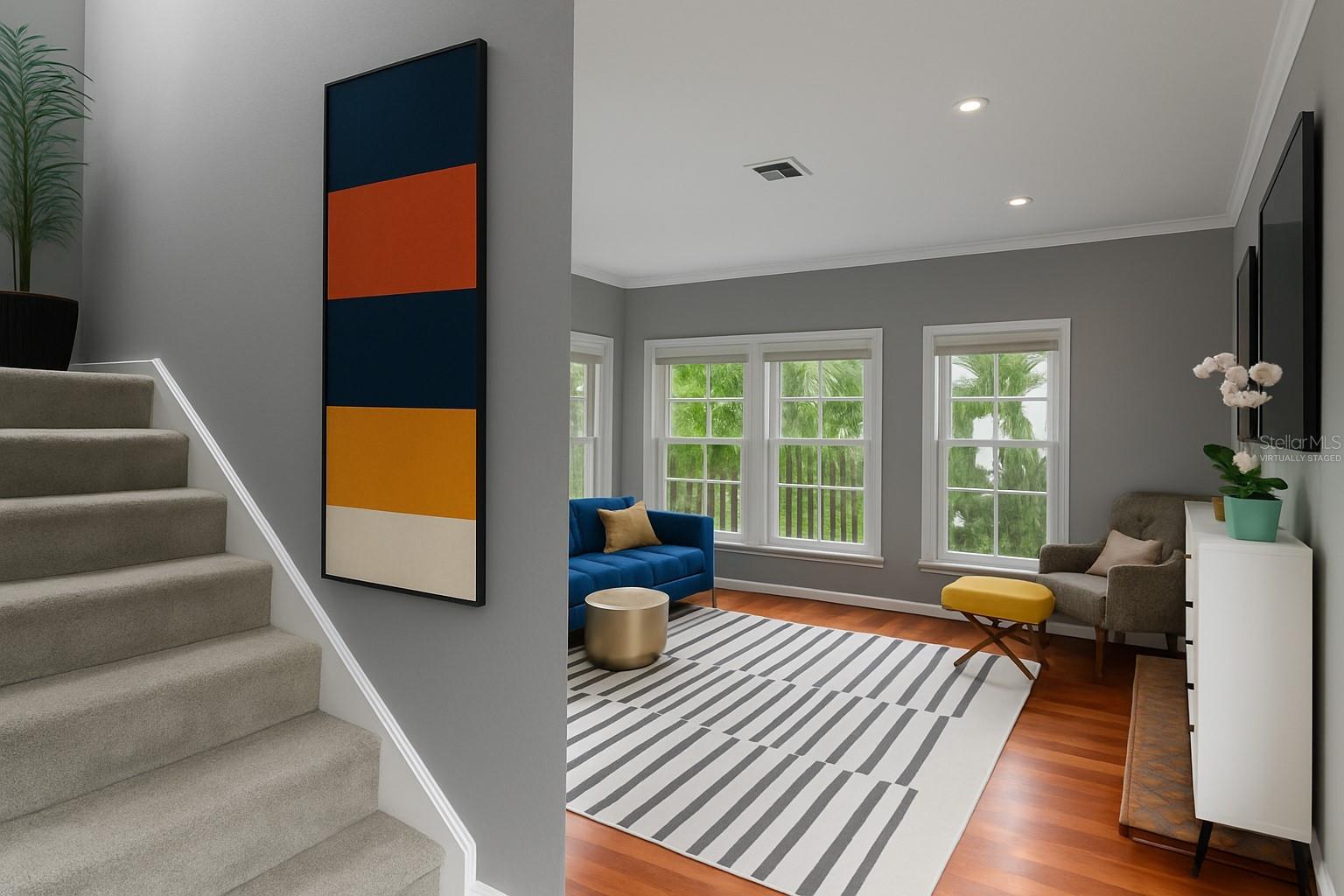 Family room up a short flight of stairs (partially virtually staged)
