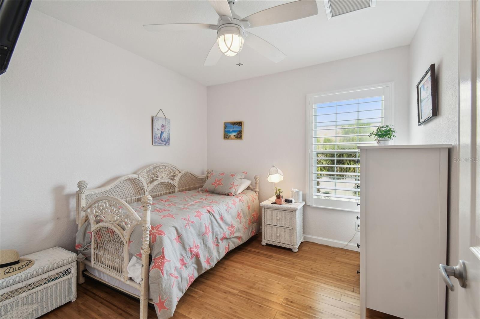 Guest Bedroom with bamboo flooring, plantation shutters, new lighting, overlooking the pool.