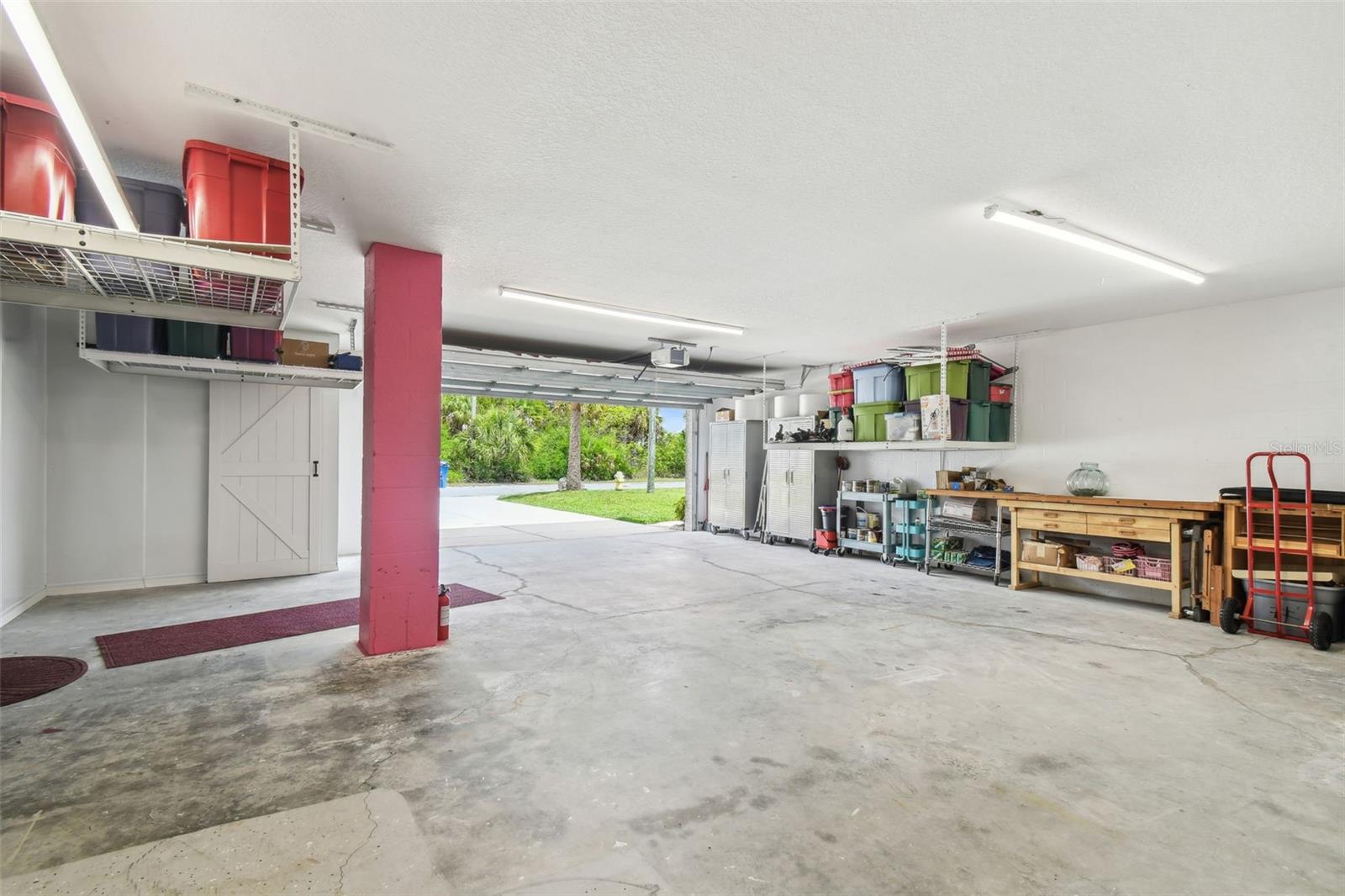 Oversized 2 car garage PLUS a separate storage room.... PLUS a work bench.  You could keep this as is.... or... turn it into a game room