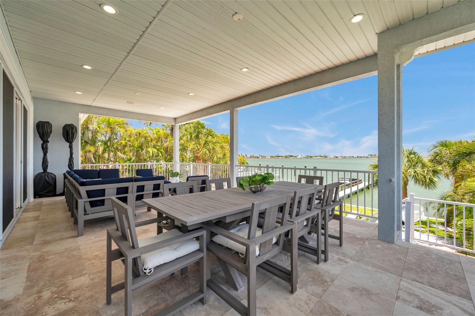 Huge covered 2nd story balcony with travertine tile.