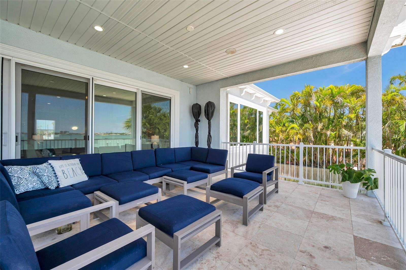 Huge covered 2nd story balcony with travertine tile.
