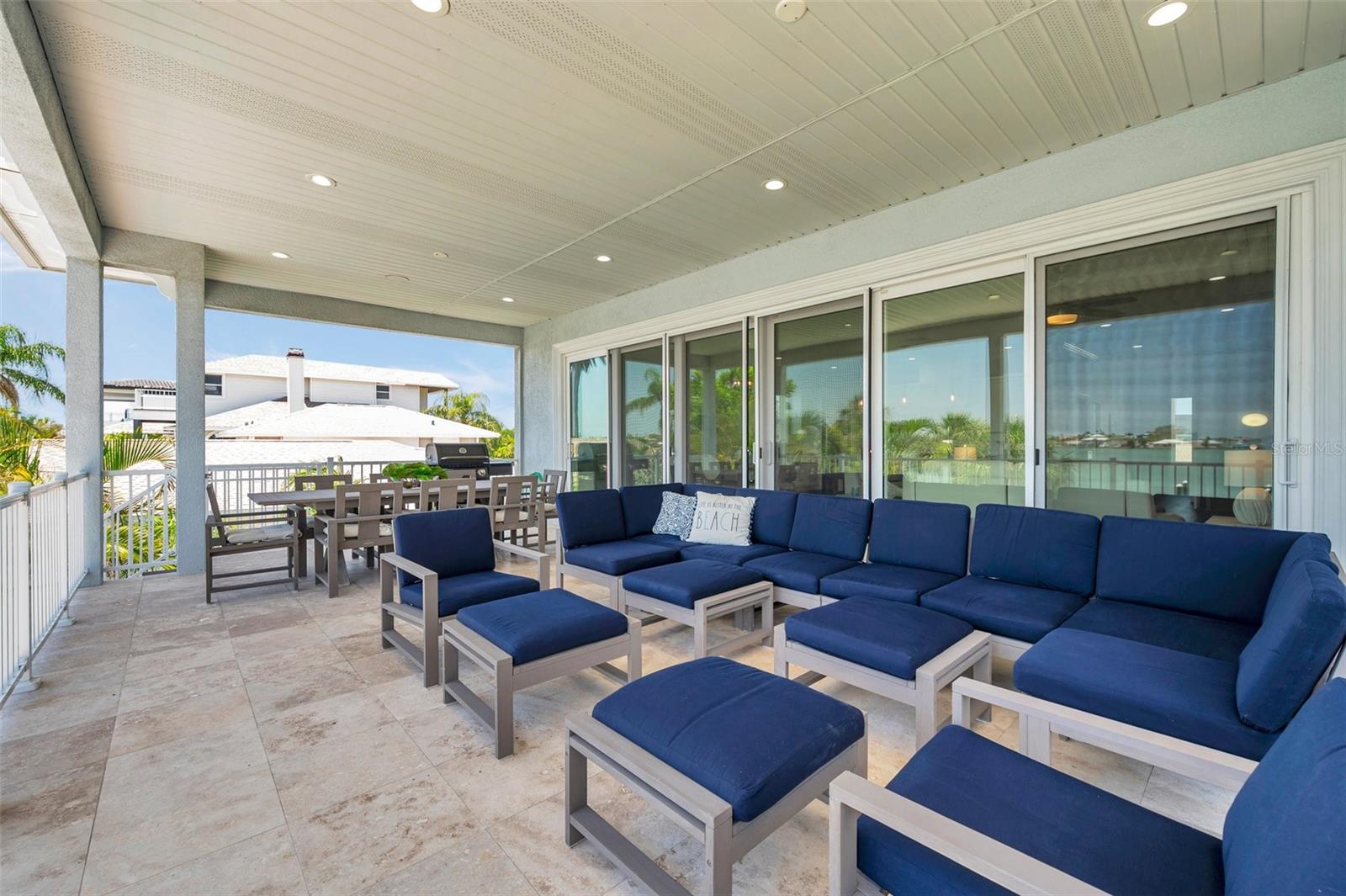 Huge covered 2nd story balcony with travertine tile.