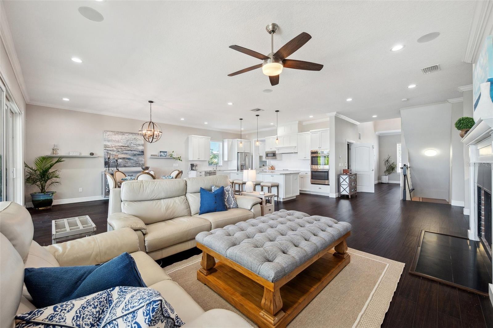 View of the 2nd level living/dining/kitchen open concept space. Wood burning fireplace to right.