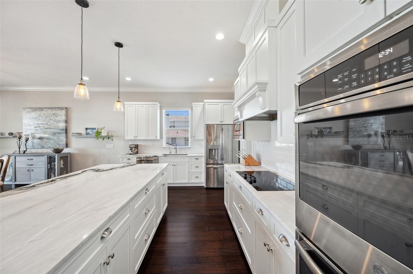 Kitchen boasts double ovens a new GE cooktop oversized center island, and reverse osmosis water filtration system.