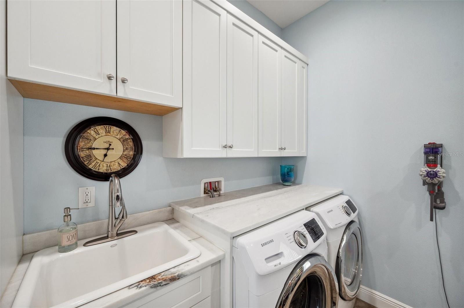 Laundry/pantry room on 2nd floor includes more custom solid wood cabinets and stone counter. And a large cast iron laundry sink.