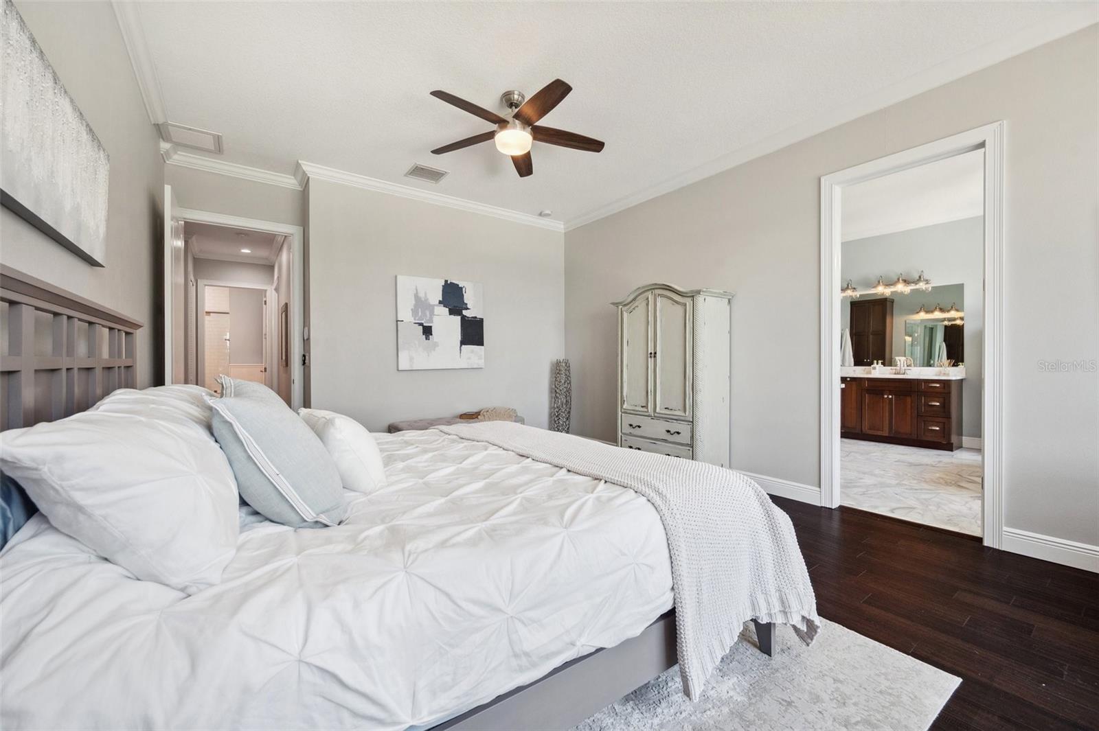 View of master bedroom with view of marble bathroom to right and entrance from hall to back left.