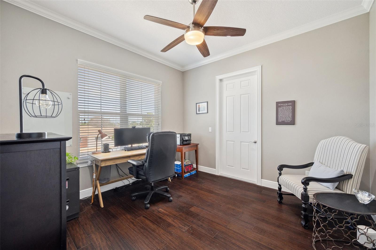 This bedroom/office is located on the 2nd floor. The door in back leads to the front balcony.