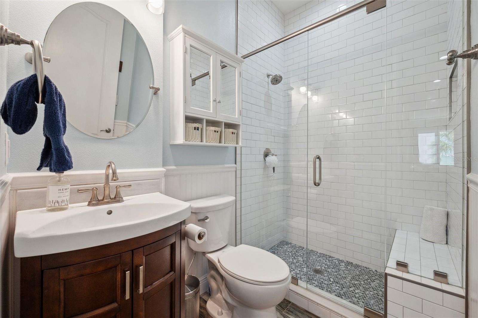 Full bath with walk-in shower and bench seat located on the second floor, just adjacent to the bedroom/office.