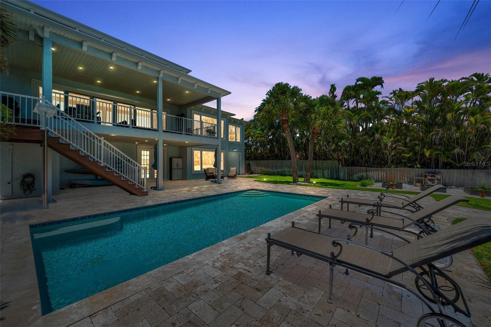 Twilight view of the pool, lanai and balcony.