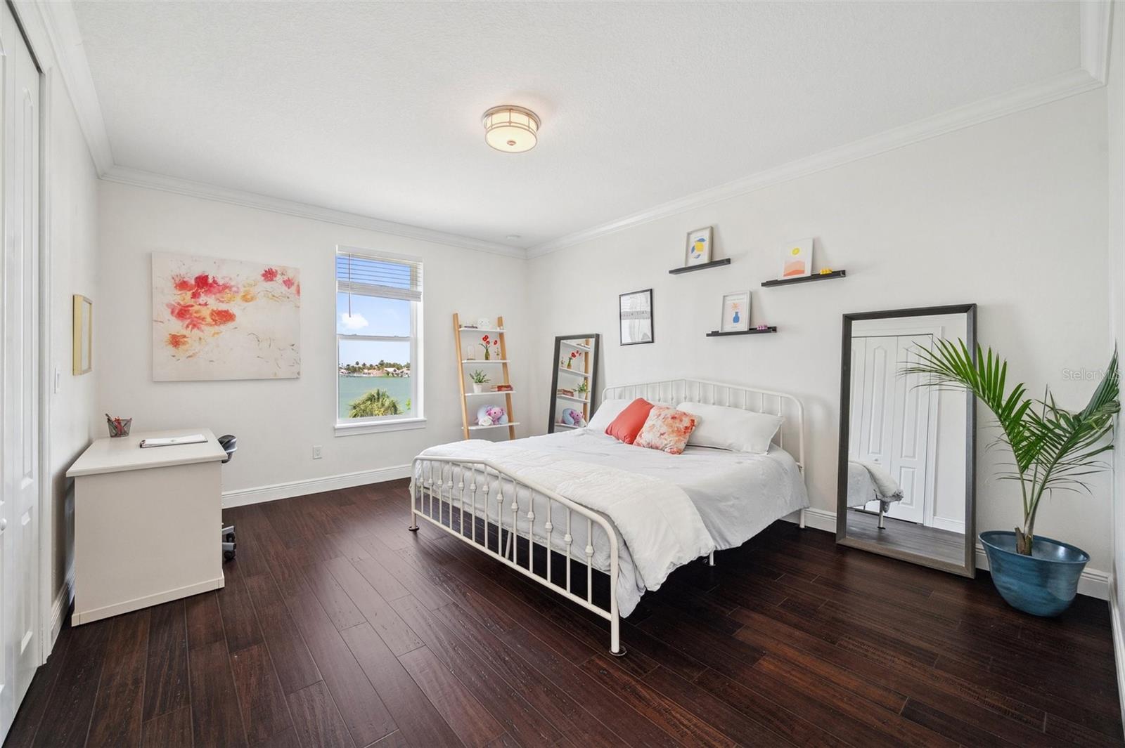 Spacious 3rd floor bedroom with water view. Closet is oversized and includes built-in shelves and drawers.