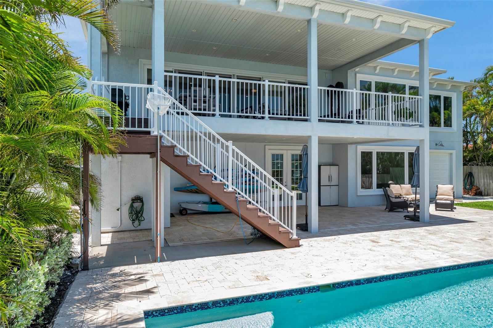 Back of this waterfront home in St Pete Beach, Florida. Here you see a portion of the travertine deck and saltwater pool.