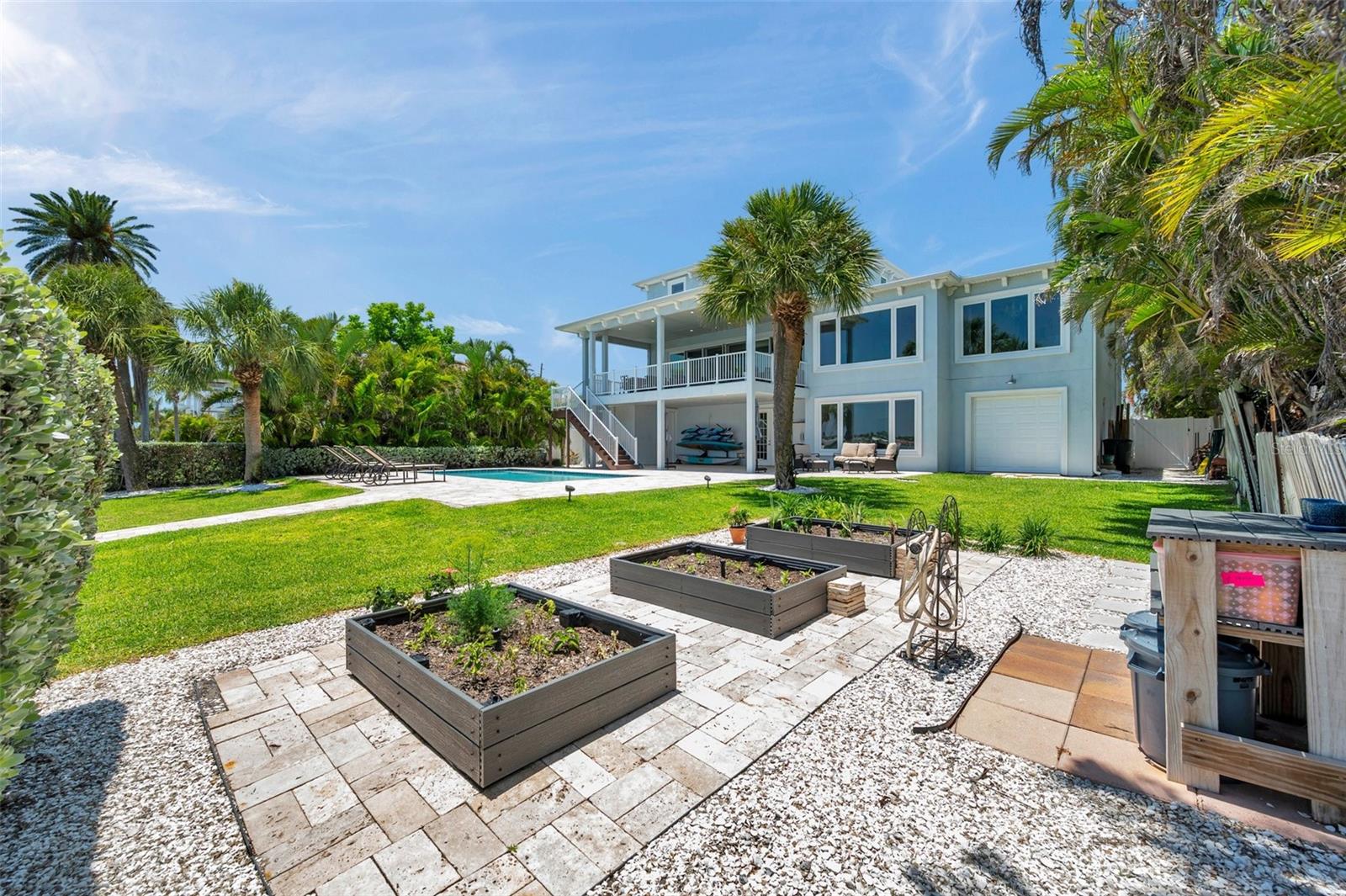 Three Trex garden boxes surrounded by travertine pavers (stay cooler!) that match the pool deck.