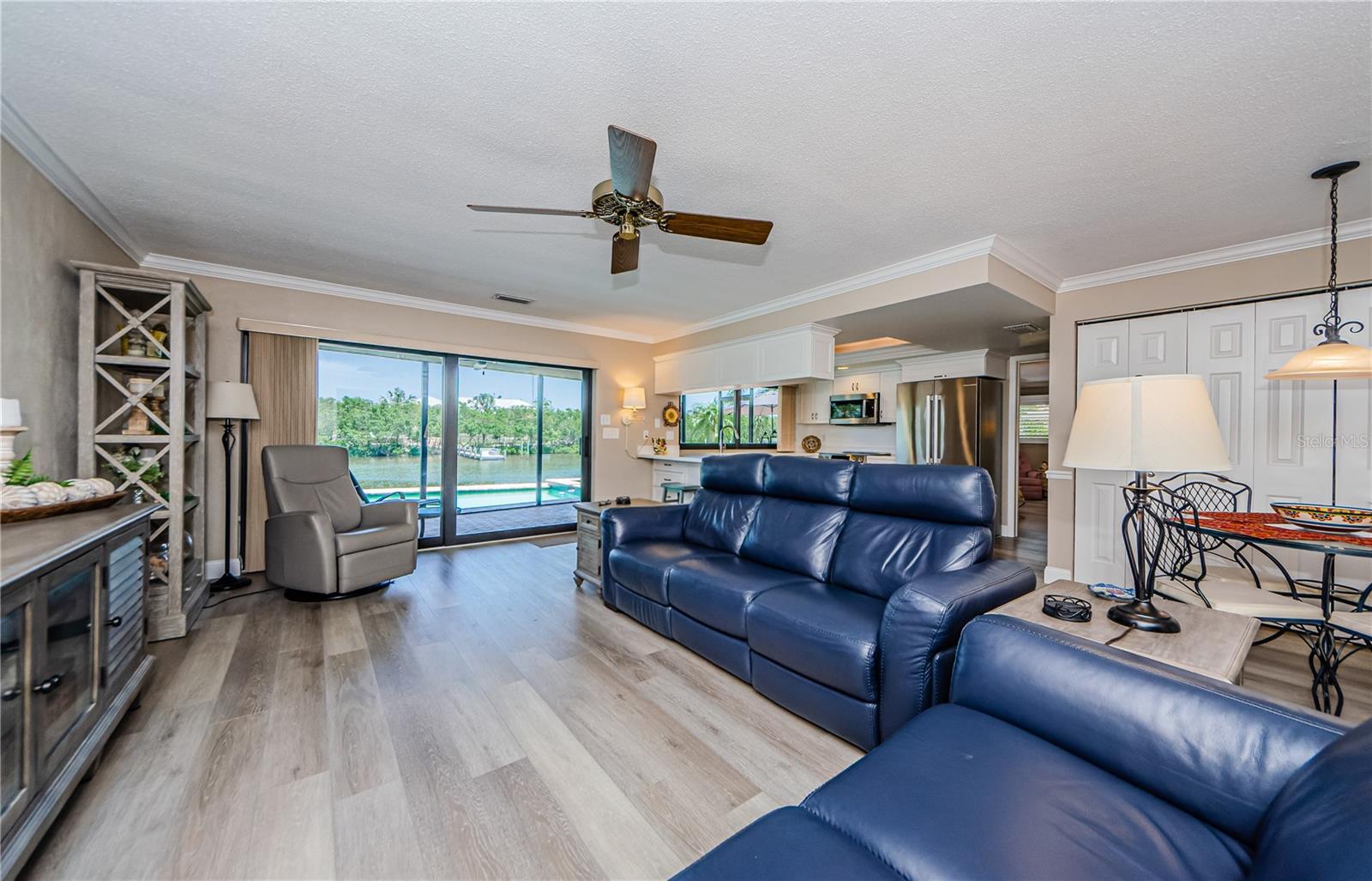 The spacious family room and kitchen enjoy one of the best views through newer hurricane rated sliders and windows!
