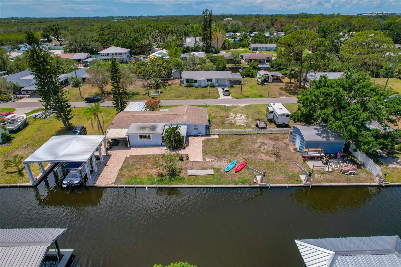 Property includes a Boathouse with a 10,000 poung sling boatlift and a 20'x18' Metal Shed with Loft