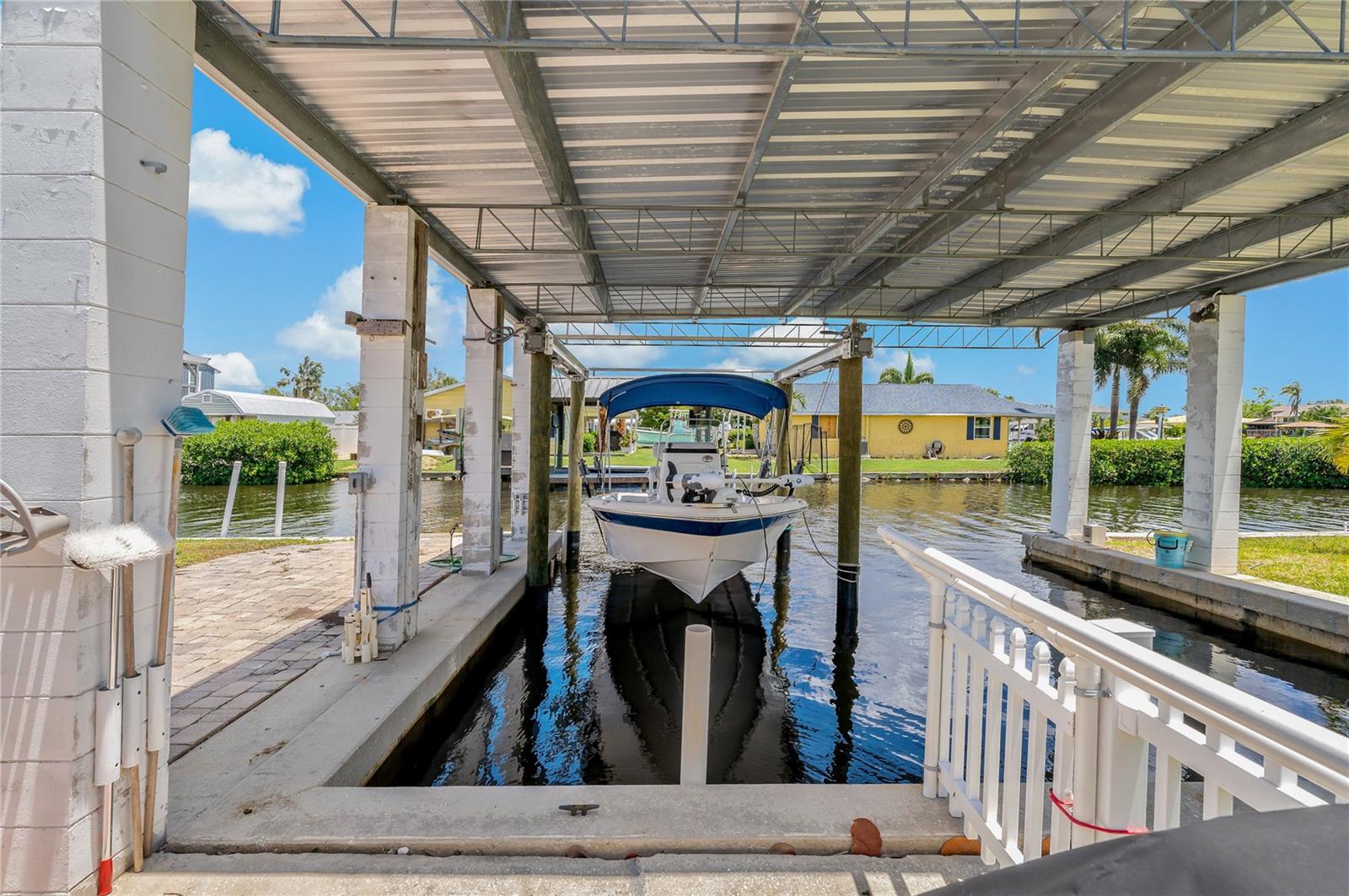 Boathouse with 10,000 pound sling Boat Lift (2024 lift, roof and pilings)