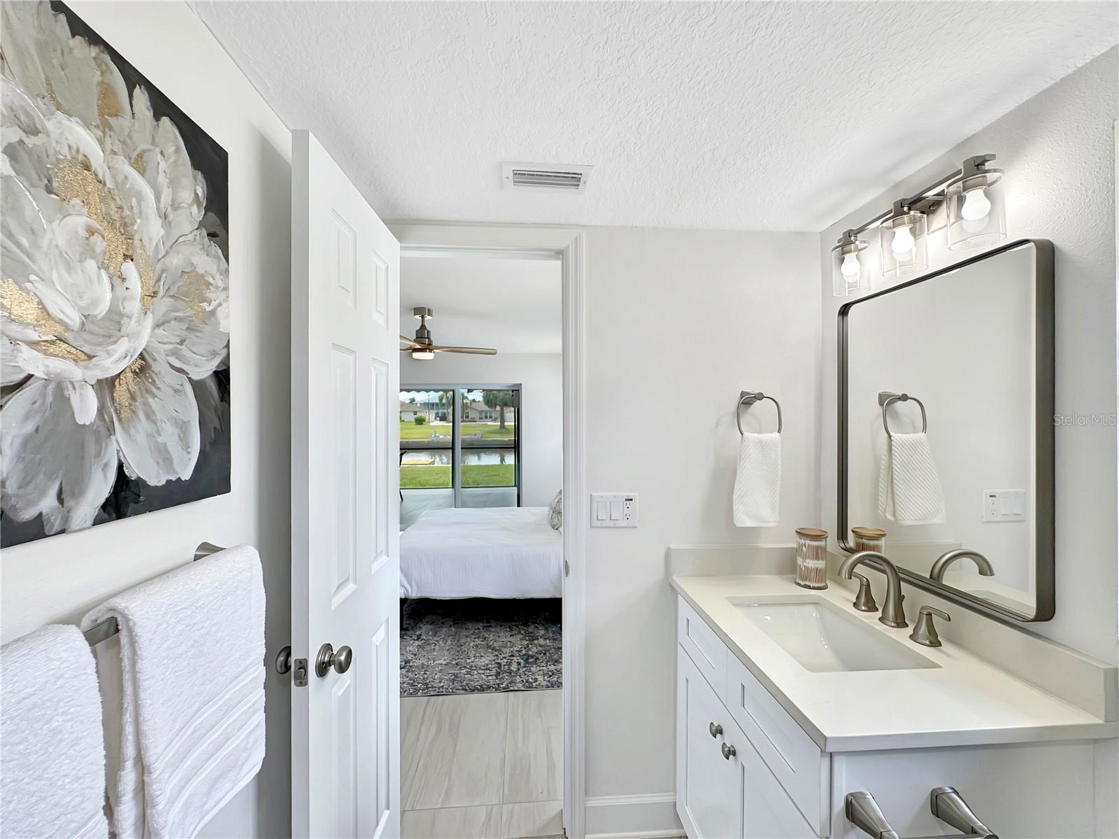 Primary Bathroom – View Toward Bedroom & Patio Access
