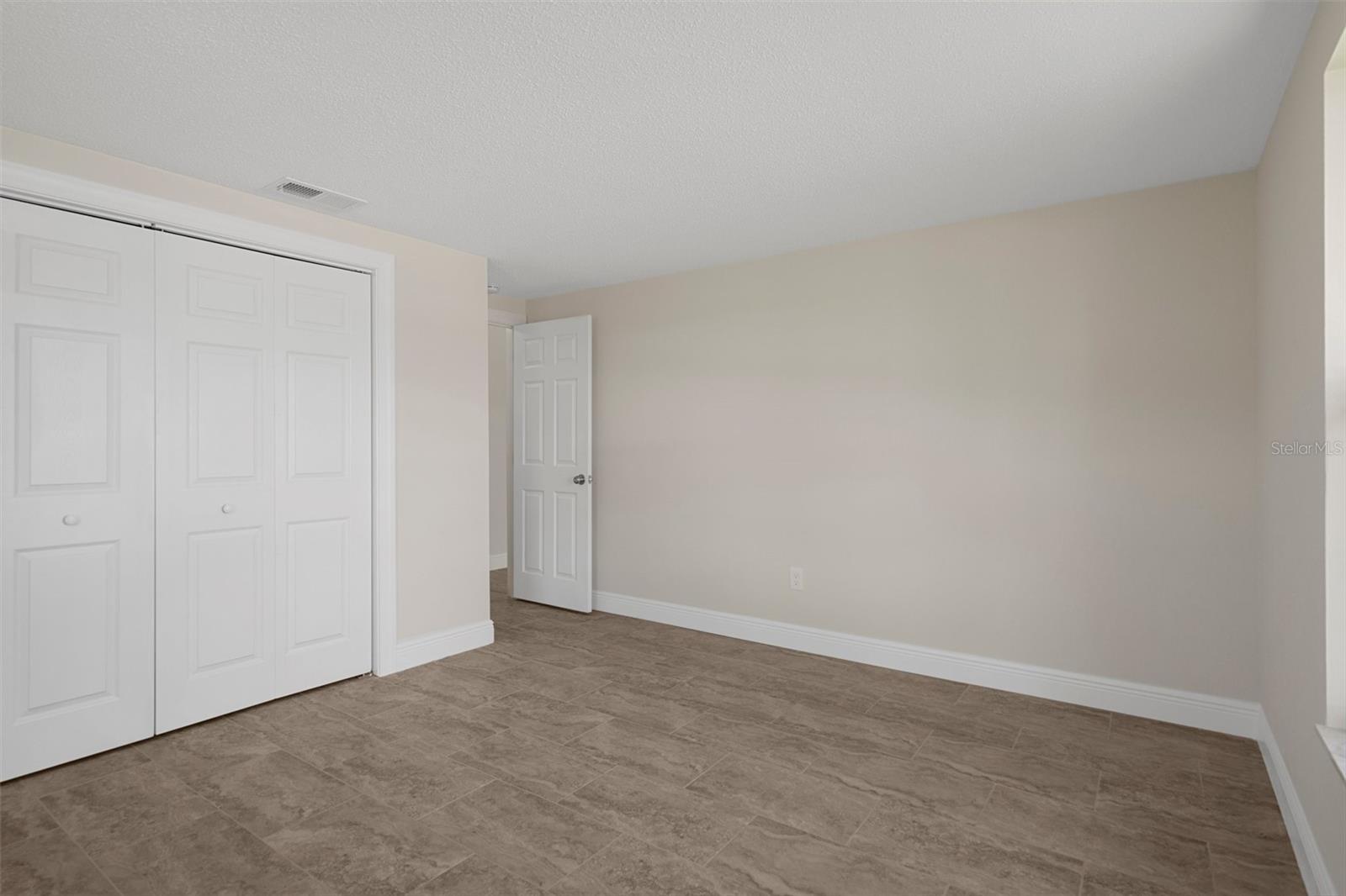 Larger bedroom faces the front of the house.