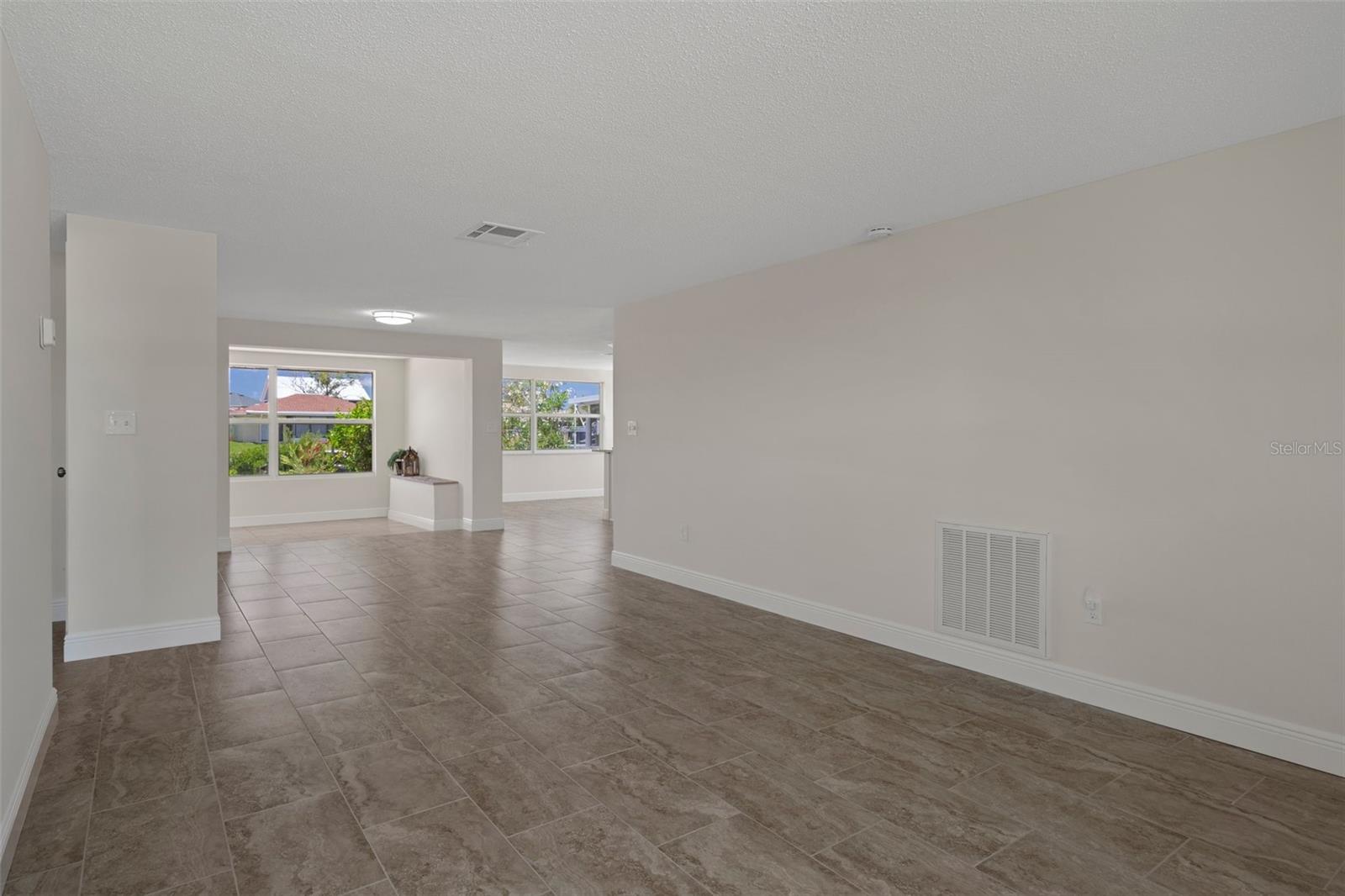 View of the Florida Room and to the right is the kitchen area with dining area.   You can also add a Dining area with the Living Room .  Large space.